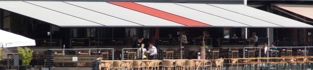 Image of multiple pergolas covering seating area outside restaurant.